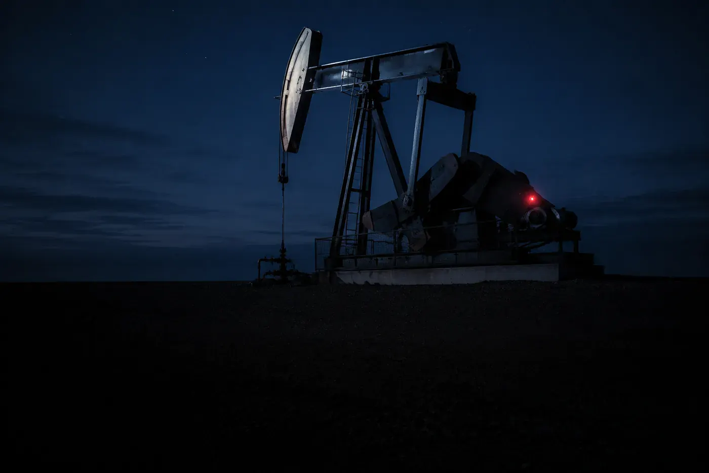 A pumpjack silhouetted against the evening sky